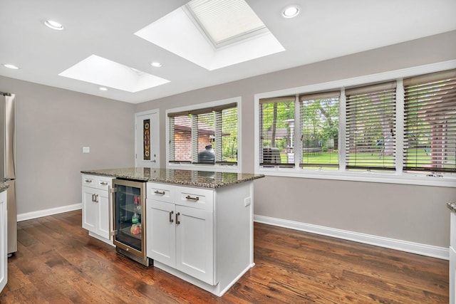 9109 W 123rd St, Palos Park, IL 60464 - kitchen with beverage cooler, baseboards, dark wood finished floors, dark stone countertops, and recessed lighting