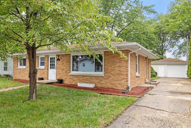 35 Lynwood Dr, Morris, IL 60450 - single story home with brick siding, an outdoor structure, a detached garage, concrete driveway, and a front yard