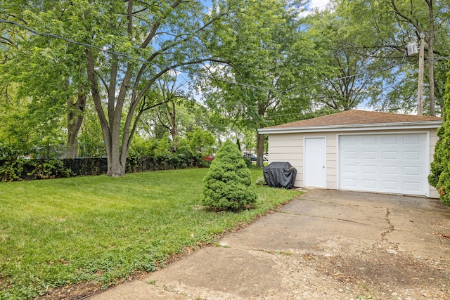 35 Lynwood Dr, Morris, IL 60450 - view of grassy yard with concrete driveway, a detached garage, and an outdoor structure