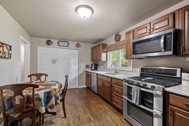 35 Lynwood Dr, Morris, IL 60450 - kitchen featuring stainless steel appliances, a sink, dark wood-style floors, and brown cabinets