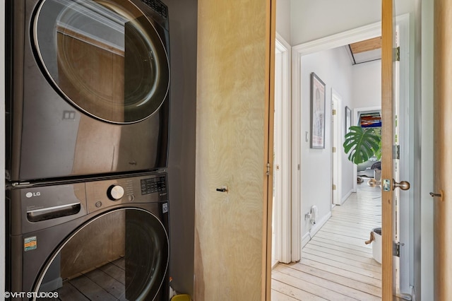 1740 N Marshfield Ave Unit 29, Chicago, IL 60622 - laundry room featuring stacked washer / dryer, hardwood / wood-style flooring, and baseboards