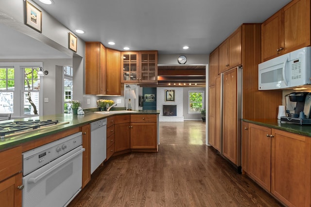 710 Longwood Dr, Lake Forest, IL 60045 - kitchen featuring white appliances, dark wood finished floors, dark countertops, brown cabinetry, and glass insert cabinets
