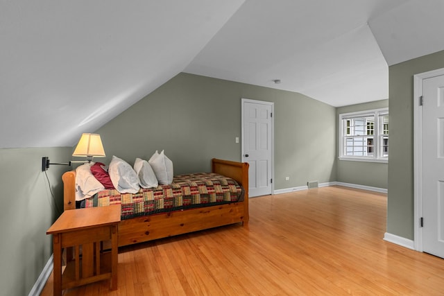710 Longwood Dr, Lake Forest, IL 60045 - bedroom with lofted ceiling, wood finished floors, and baseboards