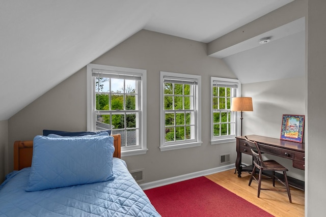 710 Longwood Dr, Lake Forest, IL 60045 - bedroom featuring vaulted ceiling, multiple windows, wood finished floors, and baseboards