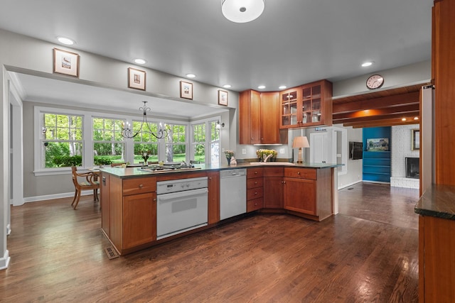 710 Longwood Dr, Lake Forest, IL 60045 - kitchen featuring stainless steel appliances, a peninsula, brown cabinetry, glass insert cabinets, and baseboards