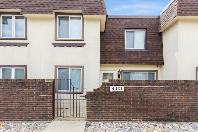 4037 Trafalgar Ln, Oak Lawn, IL 60453 - view of front facade with a shingled roof, mansard roof, and stucco siding