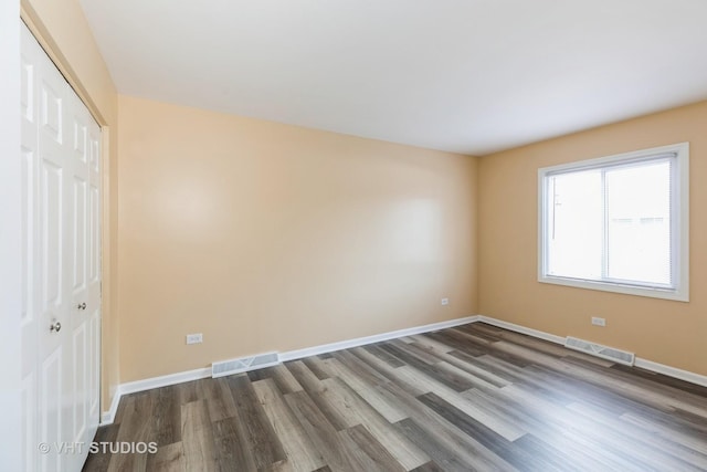 4037 Trafalgar Ln, Oak Lawn, IL 60453 - unfurnished bedroom featuring a closet, dark wood finished floors, and baseboards