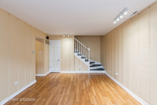 4037 Trafalgar Ln, Oak Lawn, IL 60453 - basement featuring light wood-type flooring, stairs, rail lighting, and baseboards