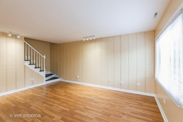 4037 Trafalgar Ln, Oak Lawn, IL 60453 - unfurnished living room featuring rail lighting, wood finished floors, stairway, and baseboards