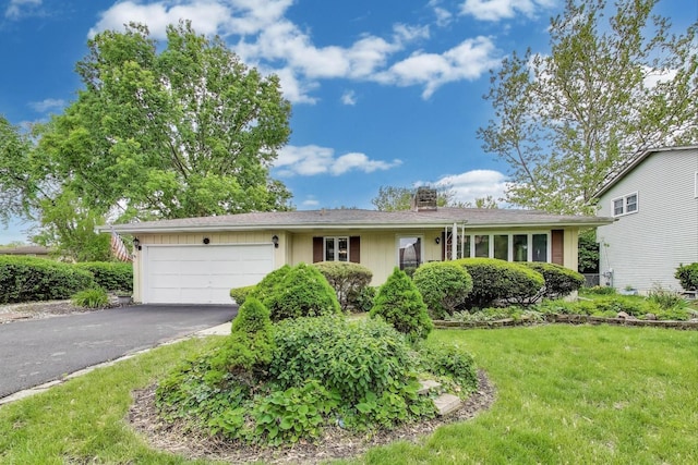 1970 Coral Ave, Aurora, IL 60506 - view of front of property with a garage, a chimney, asphalt driveway, and a front yard