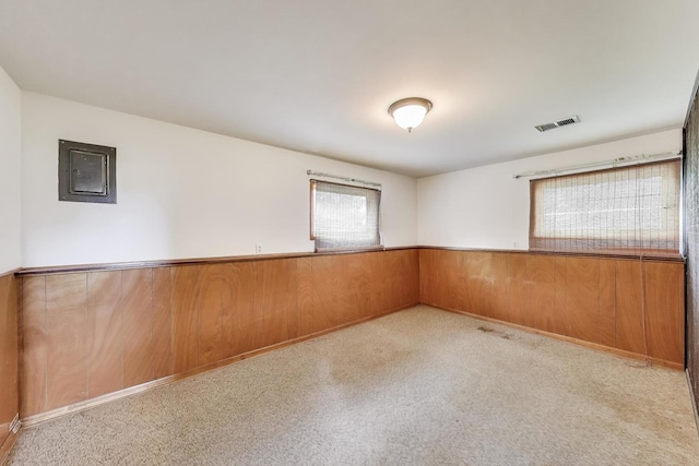 1970 Coral Ave, Aurora, IL 60506 - unfurnished room featuring wainscoting, electric panel, carpet, and wood walls