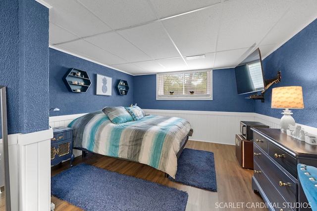 376 Belden Ave, Glendale Heights, IL 60139 - bedroom featuring a textured wall, a drop ceiling, wood finished floors, and wainscoting