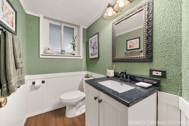 376 Belden Ave, Glendale Heights, IL 60139 - half bathroom with wood finished floors, a textured ceiling, vanity, a textured wall, and toilet