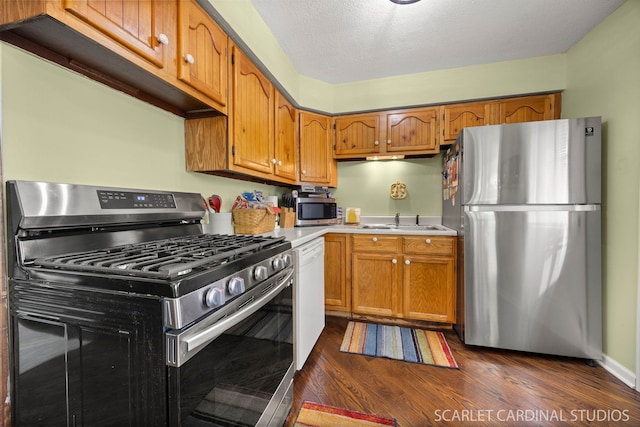 376 Belden Ave, Glendale Heights, IL 60139 - kitchen featuring appliances with stainless steel finishes, light countertops, brown cabinets, dark wood-style flooring, and a sink