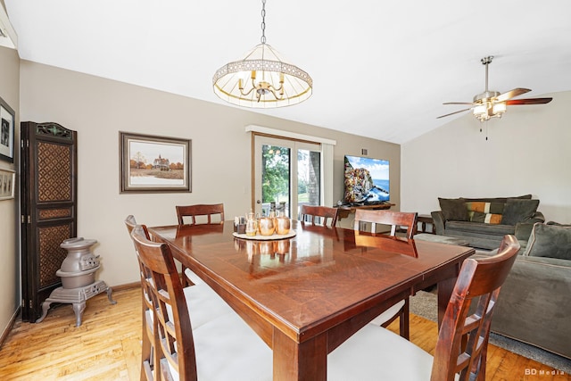 13443 S Forest Ln, Lockport, IL 60441 - dining room with light wood-style floors, vaulted ceiling, ceiling fan, a chandelier, and baseboards