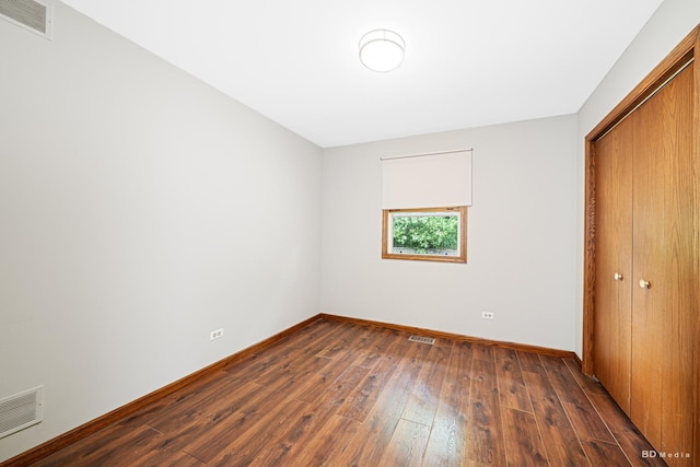 13443 S Forest Ln, Lockport, IL 60441 - unfurnished bedroom with dark wood finished floors, baseboards, and a closet