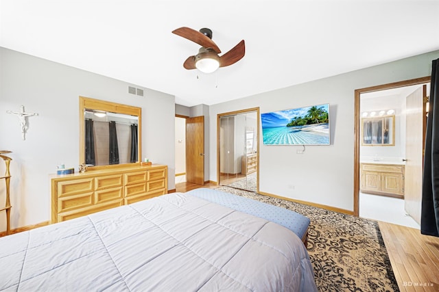 13443 S Forest Ln, Lockport, IL 60441 - bedroom with light wood finished floors, baseboards, ensuite bath, and a ceiling fan