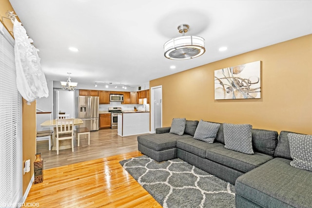 17124 Langley Ave, South Holland, IL 60473 - living room featuring a chandelier, light wood finished floors, recessed lighting, and rail lighting