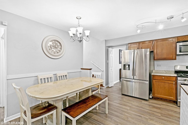 17124 Langley Ave, South Holland, IL 60473 - dining space featuring a chandelier, light wood finished floors, and baseboards