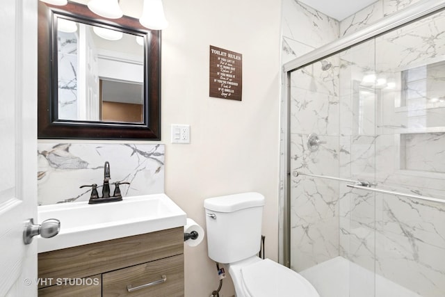 17124 Langley Ave, South Holland, IL 60473 - bathroom featuring vanity, toilet, a marble finish shower, and decorative backsplash