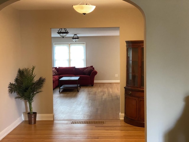 10724 S Ridgeway Ave, Chicago, IL 60655 - corridor featuring arched walkways, light wood-style flooring, and baseboards