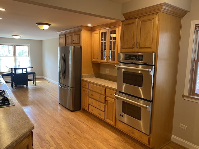 10724 S Ridgeway Ave, Chicago, IL 60655 - kitchen with stainless steel appliances, brown cabinetry, light wood-type flooring, glass insert cabinets, and recessed lighting