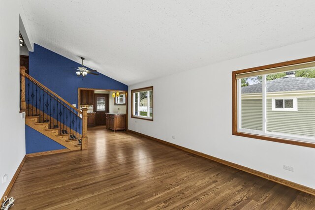525 N 3rd Ave, Villa Park, IL 60181 - unfurnished living room featuring lofted ceiling, wood finished floors, healthy amount of natural light, stairway, and ceiling fan