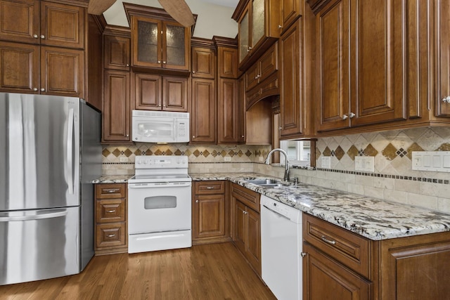 525 N 3rd Ave, Villa Park, IL 60181 - kitchen with white appliances, a sink, light stone countertops, and backsplash