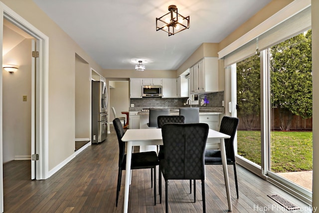 707 W Nichols Rd, Arlington Heights, IL 60004 - dining space with dark wood-style flooring and baseboards