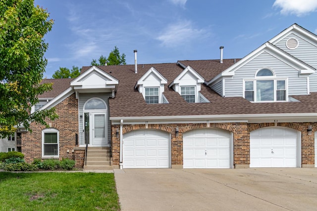 79 Willow Pkwy, Buffalo Grove, IL 60089 - view of property with roof with shingles, driveway, brick siding, a front yard, and a garage