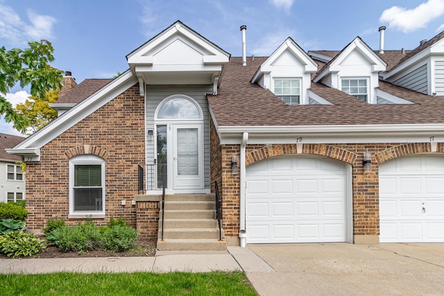 79 Willow Pkwy, Buffalo Grove, IL 60089 - view of front of house with a shingled roof, brick siding, driveway, and a chimney