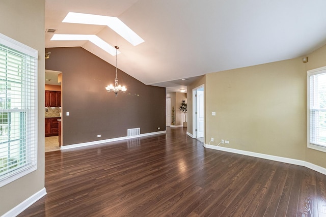 79 Willow Pkwy, Buffalo Grove, IL 60089 - unfurnished living room with a chandelier, a skylight, lofted ceiling, dark wood-style flooring, and baseboards