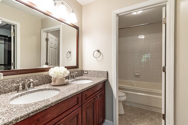 79 Willow Pkwy, Buffalo Grove, IL 60089 - bathroom featuring double vanity, toilet, shower / bathtub combination, and tile patterned flooring