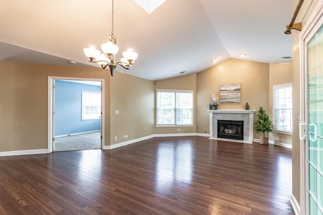 79 Willow Pkwy, Buffalo Grove, IL 60089 - unfurnished living room featuring lofted ceiling, plenty of natural light, a chandelier, wood finished floors, and a tile fireplace