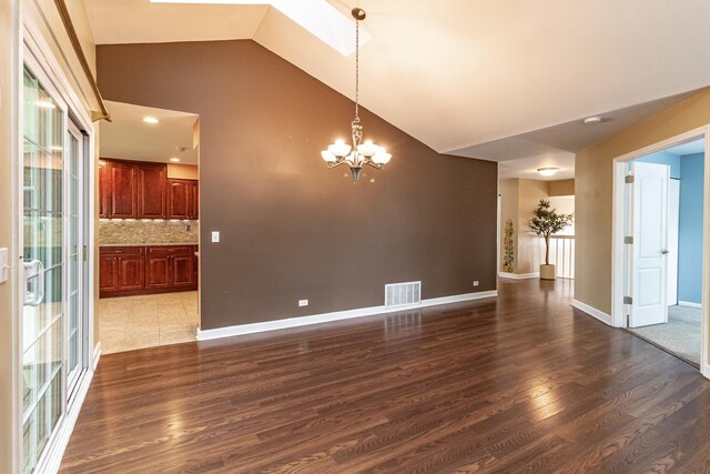 79 Willow Pkwy, Buffalo Grove, IL 60089 - unfurnished dining area featuring dark wood finished floors, a chandelier, high vaulted ceiling, and baseboards