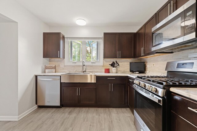 228 Oriole Rd, Matteson, IL 60443 - kitchen with appliances with stainless steel finishes, a sink, light wood-type flooring, and light countertops