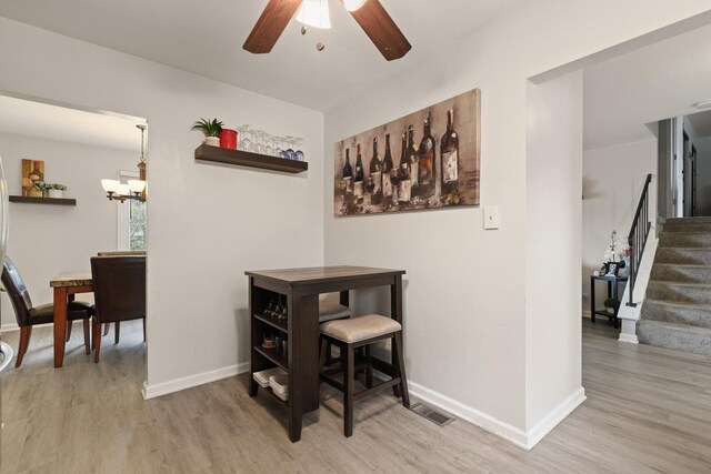 228 Oriole Rd, Matteson, IL 60443 - dining area with wood finished floors, ceiling fan, baseboards, and stairs