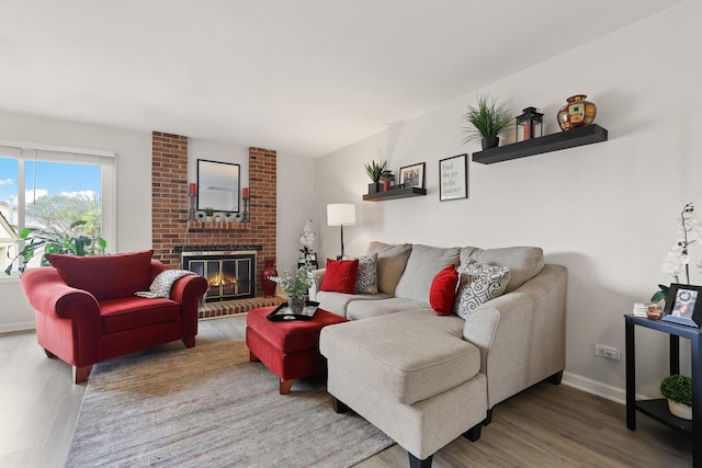 228 Oriole Rd, Matteson, IL 60443 - living room with wood finished floors, a brick fireplace, and baseboards