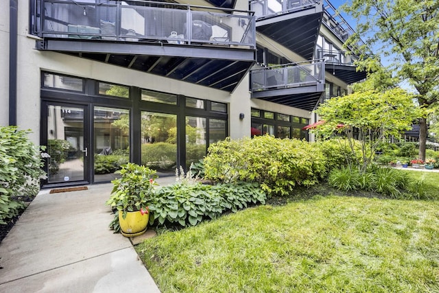 1110 W 15th St Unit 114, Chicago, IL 60608 - entrance to property featuring a balcony, a lawn, and stucco siding