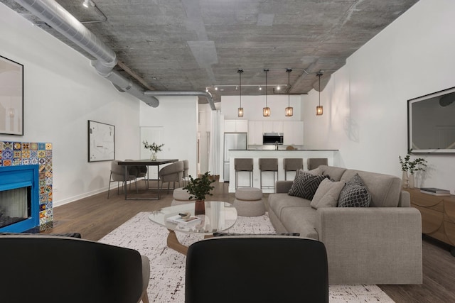 1110 W 15th St Unit 114, Chicago, IL 60608 - living room featuring wood finished floors, a tiled fireplace, and baseboards