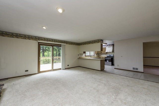 12375 W Ash Ct, Beach Park, IL 60099 - unfurnished living room featuring baseboards and light carpet