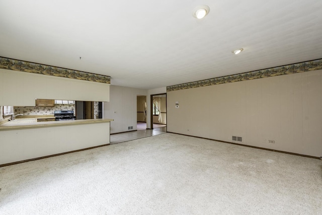 12375 W Ash Ct, Beach Park, IL 60099 - unfurnished living room with a sink and baseboards