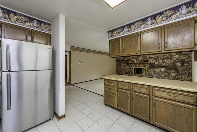 12375 W Ash Ct, Beach Park, IL 60099 - kitchen with freestanding refrigerator, light tile patterned floors, light countertops, and baseboards