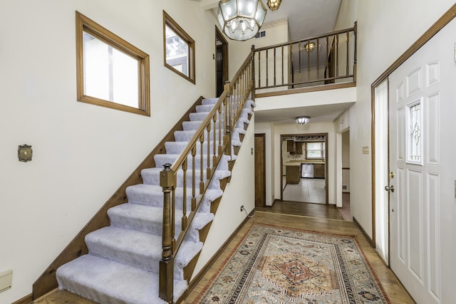 12375 W Ash Ct, Beach Park, IL 60099 - entrance foyer featuring a chandelier, stairway, wood finished floors, and a high ceiling