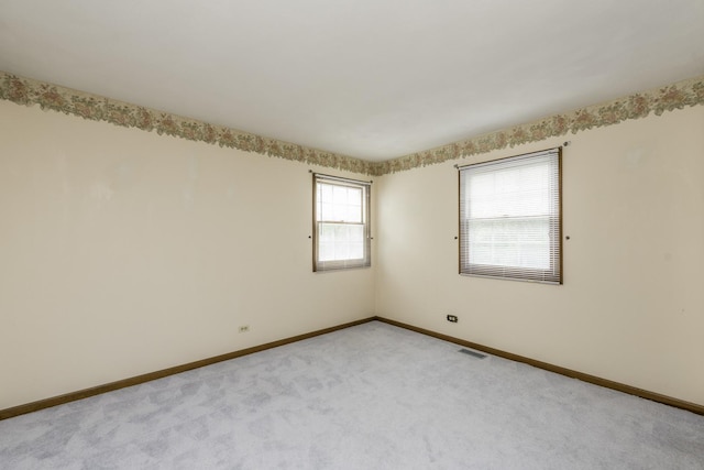 12375 W Ash Ct, Beach Park, IL 60099 - spare room featuring baseboards and light carpet