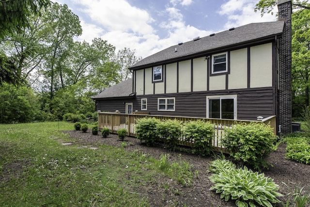 12375 W Ash Ct, Beach Park, IL 60099 - rear view of property with board and batten siding, a deck, and a chimney