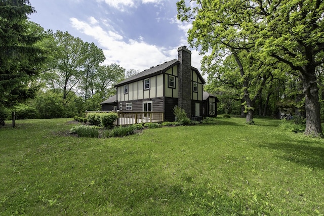 12375 W Ash Ct, Beach Park, IL 60099 - view of side of property with a chimney, a lawn, and a deck