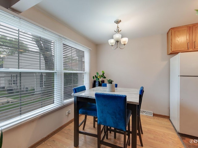 426 James Ct Unit C, Glendale Heights, IL 60139 - dining area with light wood-style flooring, a chandelier, and baseboards