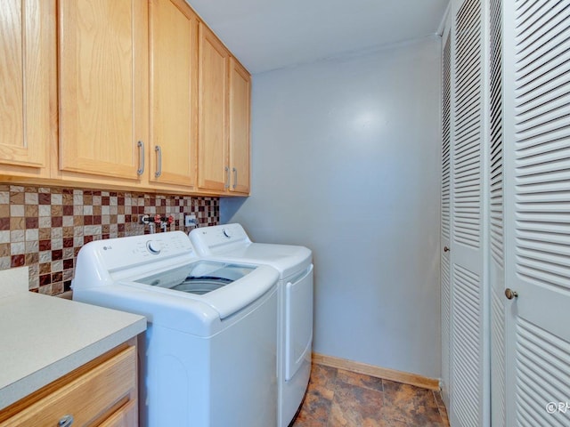 426 James Ct Unit C, Glendale Heights, IL 60139 - washroom featuring cabinet space, washer and clothes dryer, baseboards, and dark stone finish flooring