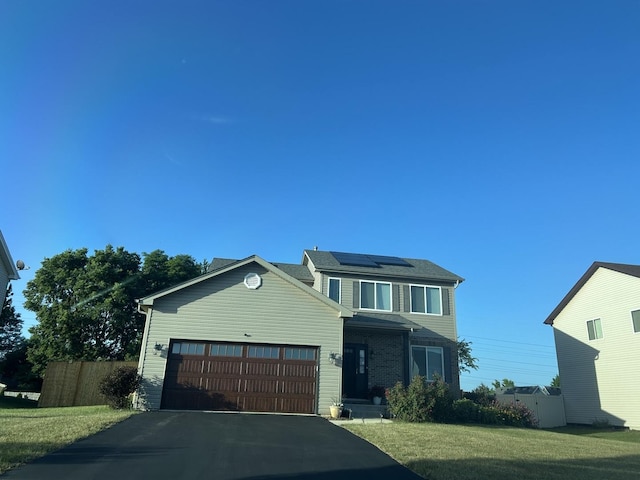615 Camellia Ave, Aurora, IL 60505 - view of front of home with solar panels, an attached garage, and driveway